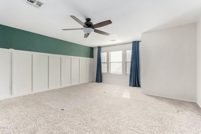 carpeted empty room featuring ceiling fan