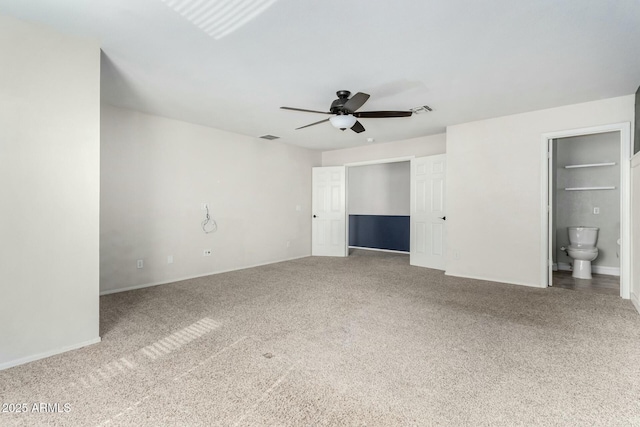 unfurnished bedroom with ceiling fan, carpet, and ensuite bath