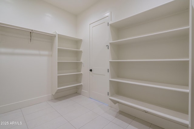 walk in closet with tile patterned floors