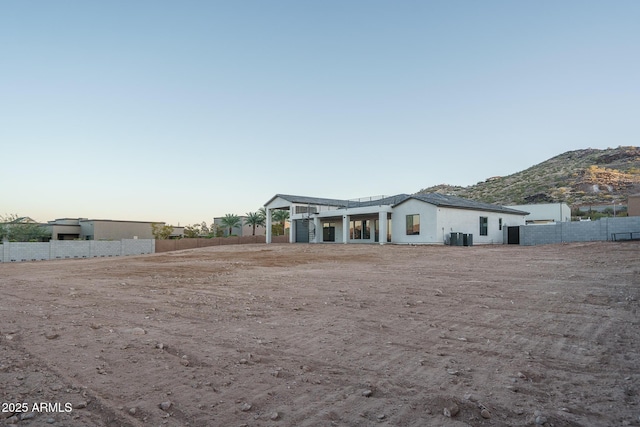 view of front of property featuring a mountain view and cooling unit