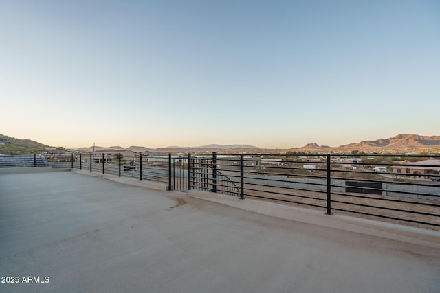 patio terrace at dusk featuring a mountain view