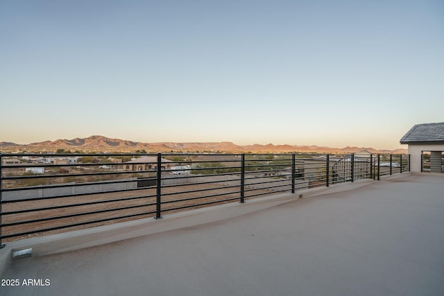 patio terrace at dusk featuring a mountain view