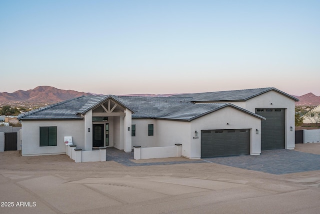 view of front of home with a garage and a mountain view