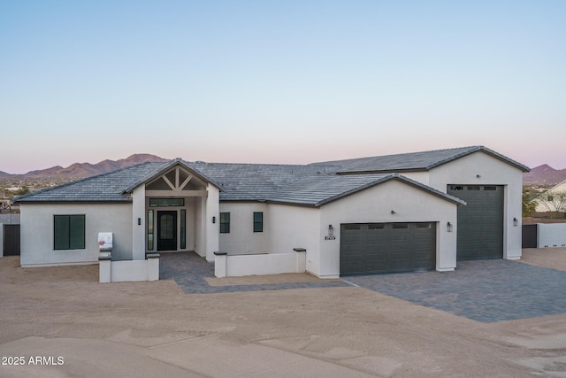 view of front of home featuring a garage and a mountain view