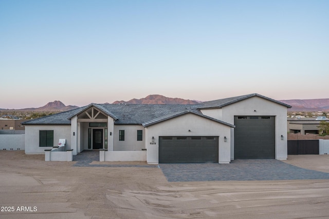 view of front of house with a garage and a mountain view