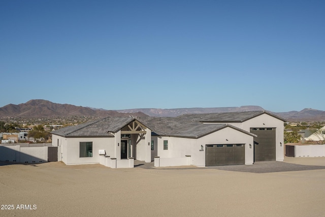 view of front facade with a mountain view and a garage