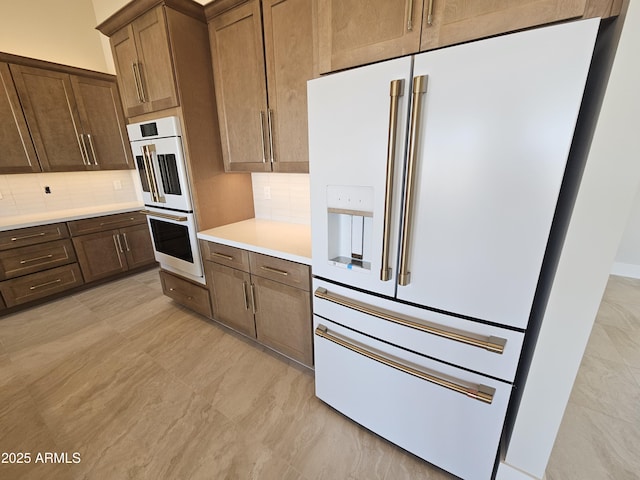 kitchen with white appliances and decorative backsplash