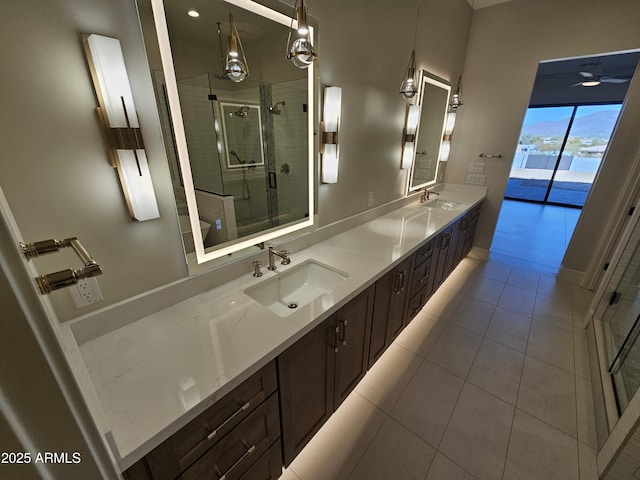 bathroom with an enclosed shower, vanity, and tile patterned floors