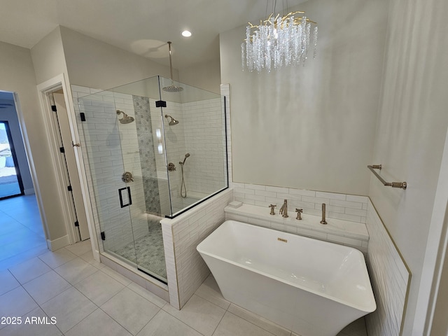 bathroom with tile patterned floors and shower with separate bathtub