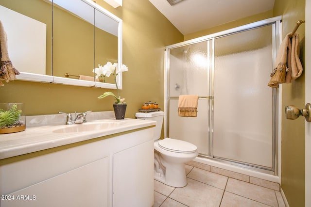 bathroom with tile patterned flooring, vanity, walk in shower, and toilet