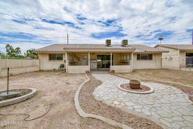 back of property featuring cooling unit and a patio