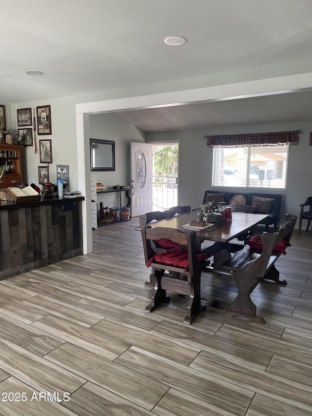 dining room featuring wood finish floors and a textured ceiling