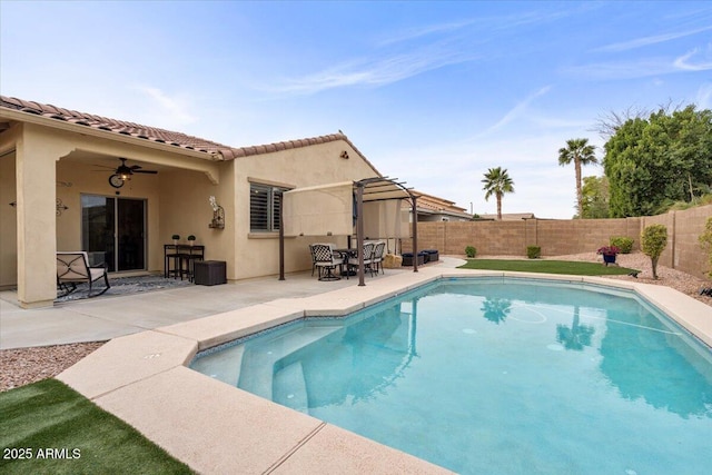 view of swimming pool featuring ceiling fan and a patio area