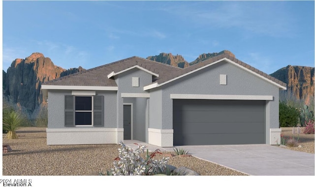 ranch-style home with stucco siding, driveway, an attached garage, and a mountain view