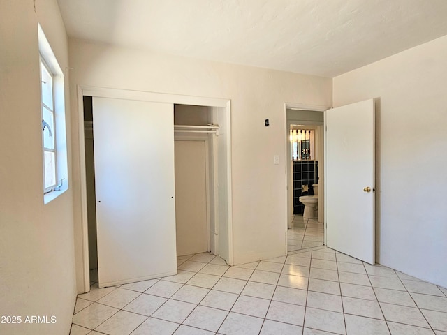 1374 S Naco Hwy, Bisbee, AZ 85603 - unfurnished bedroom with multiple windows, light tile patterned floors, and a closet