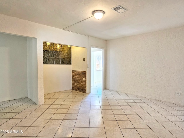 1374 S Naco Hwy, Bisbee, AZ 85603 - spare room featuring a textured wall and light tile patterned flooring