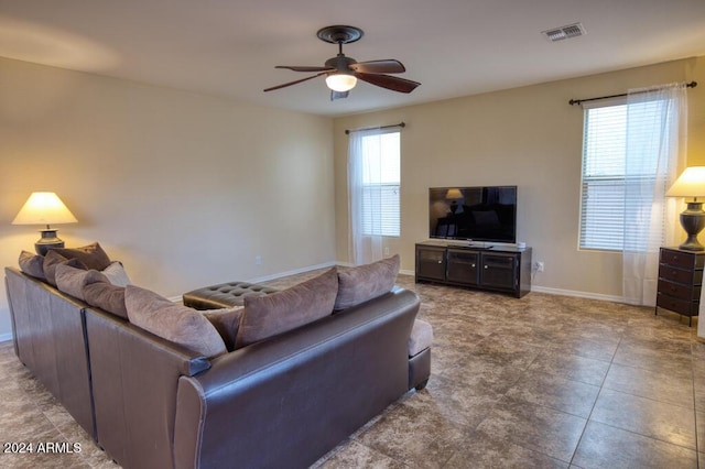 living room with tile patterned floors and ceiling fan