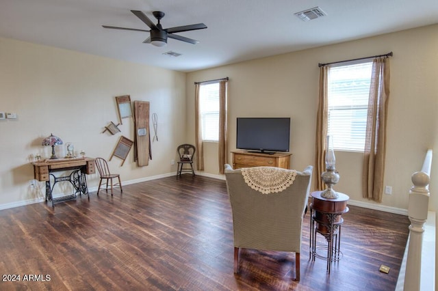 sitting room featuring ceiling fan, dark hardwood / wood-style flooring, and a wealth of natural light