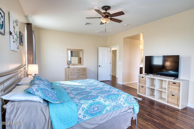 bedroom featuring dark hardwood / wood-style floors, ceiling fan, and ensuite bathroom