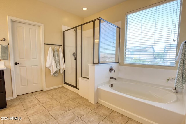 bathroom with tile patterned flooring, plenty of natural light, and vanity