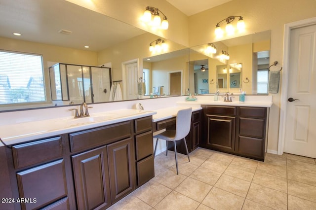 bathroom with ceiling fan, tile patterned flooring, vanity, and walk in shower