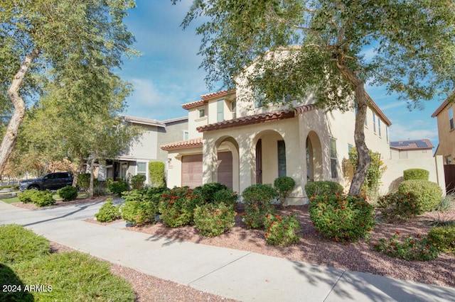 mediterranean / spanish home with a garage