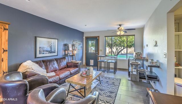 living room with tile patterned flooring and ceiling fan