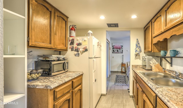 kitchen with sink and white refrigerator