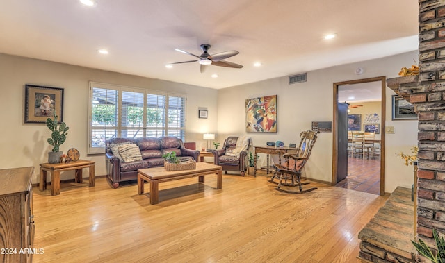 living room with ceiling fan and light hardwood / wood-style floors