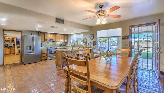 dining space featuring ceiling fan and light tile patterned floors