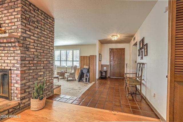 tiled entryway featuring a fireplace