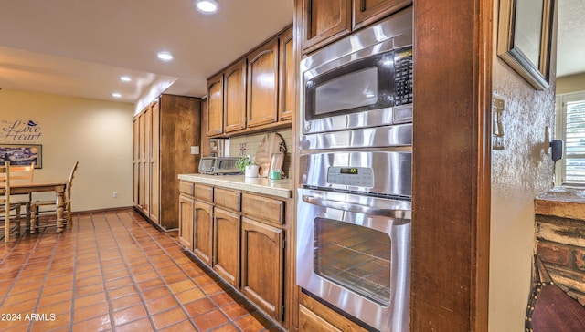 kitchen featuring tile countertops, tile patterned floors, and appliances with stainless steel finishes