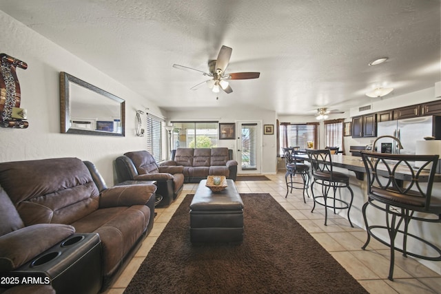 13160 W Windsor Ave, Goodyear, AZ 85395 - living room featuring a ceiling fan, light tile patterned flooring, and a textured ceiling