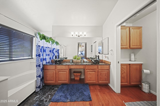13160 W Windsor Ave, Goodyear, AZ 85395 - full bathroom with a chandelier, double vanity, a tub to relax in, and healthy amount of natural light