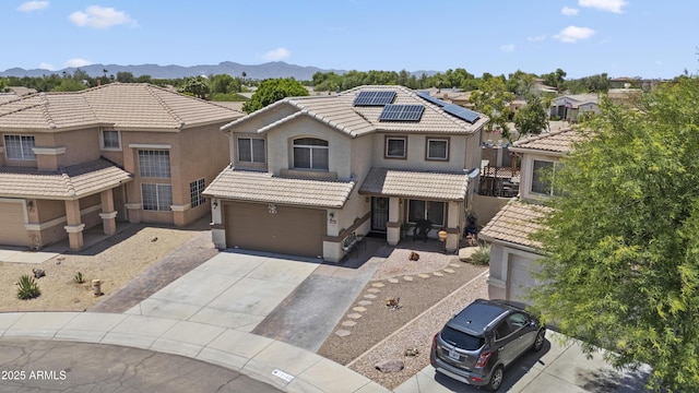 13160 W Windsor Ave, Goodyear, AZ 85395 - view of front of home with driveway, an attached garage, roof mounted solar panels, and stucco siding