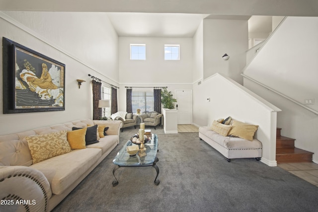 13160 W Windsor Ave, Goodyear, AZ 85395 - tiled living room featuring a high ceiling, stairs, and carpet