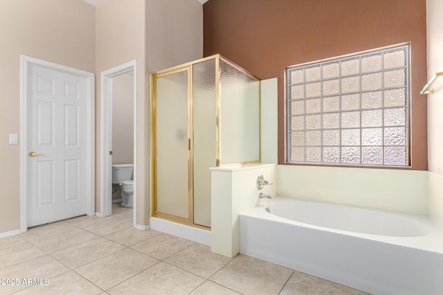 bathroom featuring tile patterned floors, toilet, and shower with separate bathtub