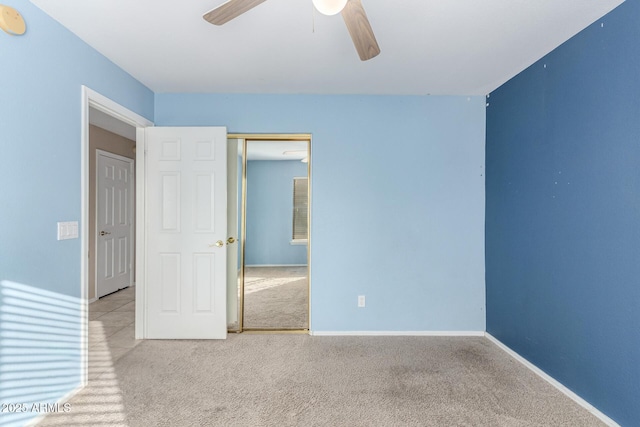 carpeted empty room featuring ceiling fan