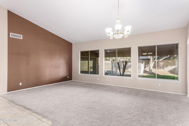 unfurnished room with light carpet, plenty of natural light, lofted ceiling, and an inviting chandelier