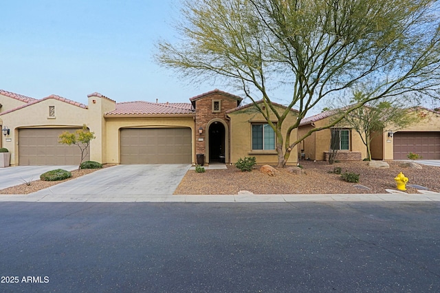 mediterranean / spanish-style house with a garage