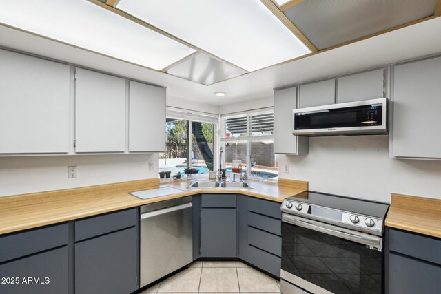 3833 W Phelps Rd, Phoenix, AZ 85053 - kitchen featuring appliances with stainless steel finishes, gray cabinetry, a sink, and recessed lighting