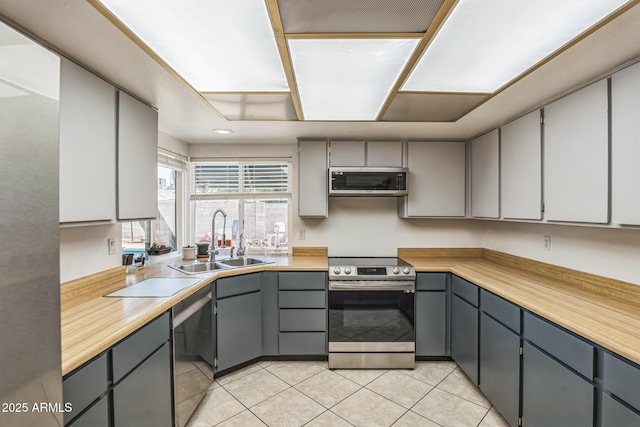 3833 W Phelps Rd, Phoenix, AZ 85053 - kitchen featuring stainless steel appliances, a sink, gray cabinets, and light tile patterned flooring