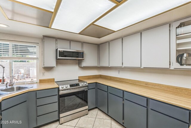3833 W Phelps Rd, Phoenix, AZ 85053 - kitchen with appliances with stainless steel finishes, gray cabinets, light tile patterned flooring, a sink, and recessed lighting