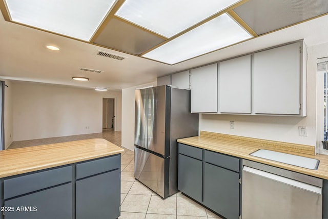 3833 W Phelps Rd, Phoenix, AZ 85053 - kitchen with appliances with stainless steel finishes, light tile patterned floors, gray cabinets, and recessed lighting