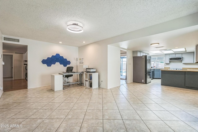 3833 W Phelps Rd, Phoenix, AZ 85053 - unfurnished living room featuring a textured ceiling and light tile patterned floors
