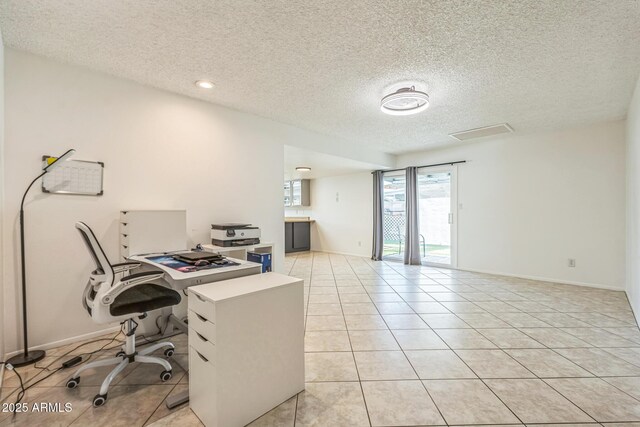 3833 W Phelps Rd, Phoenix, AZ 85053 - home office featuring light tile patterned floors, a textured ceiling, and baseboards
