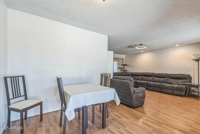 3833 W Phelps Rd, Phoenix, AZ 85053 - dining area featuring a textured ceiling and light wood-type flooring