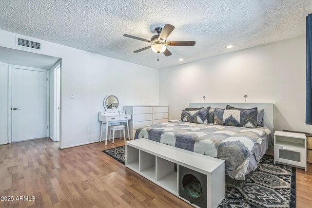 3833 W Phelps Rd, Phoenix, AZ 85053 - bedroom with a textured ceiling, wood finished floors, recessed lighting, a ceiling fan, and baseboards
