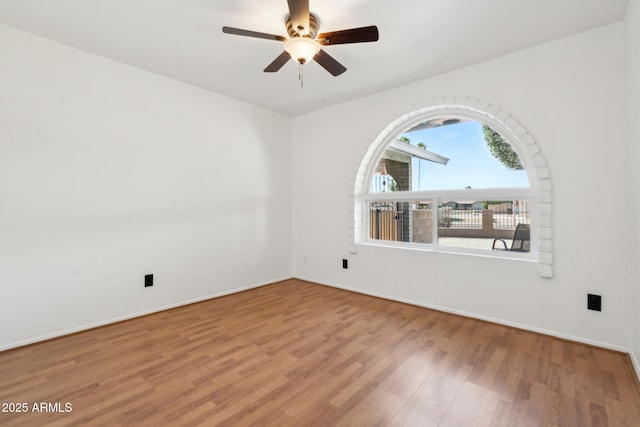 3833 W Phelps Rd, Phoenix, AZ 85053 - unfurnished room featuring wood finished floors, a ceiling fan, and baseboards