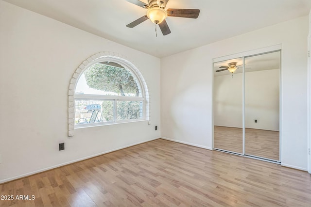 3833 W Phelps Rd, Phoenix, AZ 85053 - unfurnished bedroom with wood finished floors, a closet, baseboards, and ceiling fan